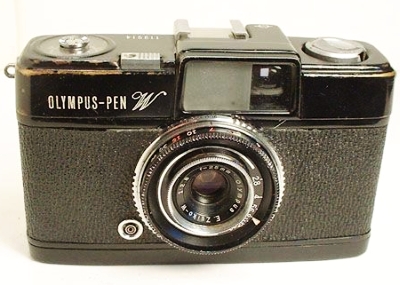 "Since this model sold for only two years, it is one of the more unusual models. It is basically the same as the Pen S, but had a slightly wider-angle, six-element, semi wide angle Zuiko 25mm (f2.8 - 22) manually-focusing lens. Focus was from 2 feet to infinity with click stops at 7 and 15 feet. Built-in tripod socket and cable release socket. On the front it says Pen W and it was only available in a black body. It also had a PC connection and a cold flash shoe. No meter. Shutter speeds of B, 1/8 - 1/250."