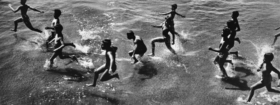 Boys running into surf, 1954