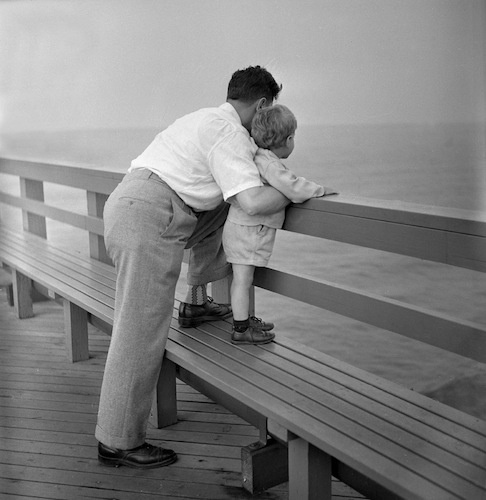 Father and Son at boardwalk rail, 1948