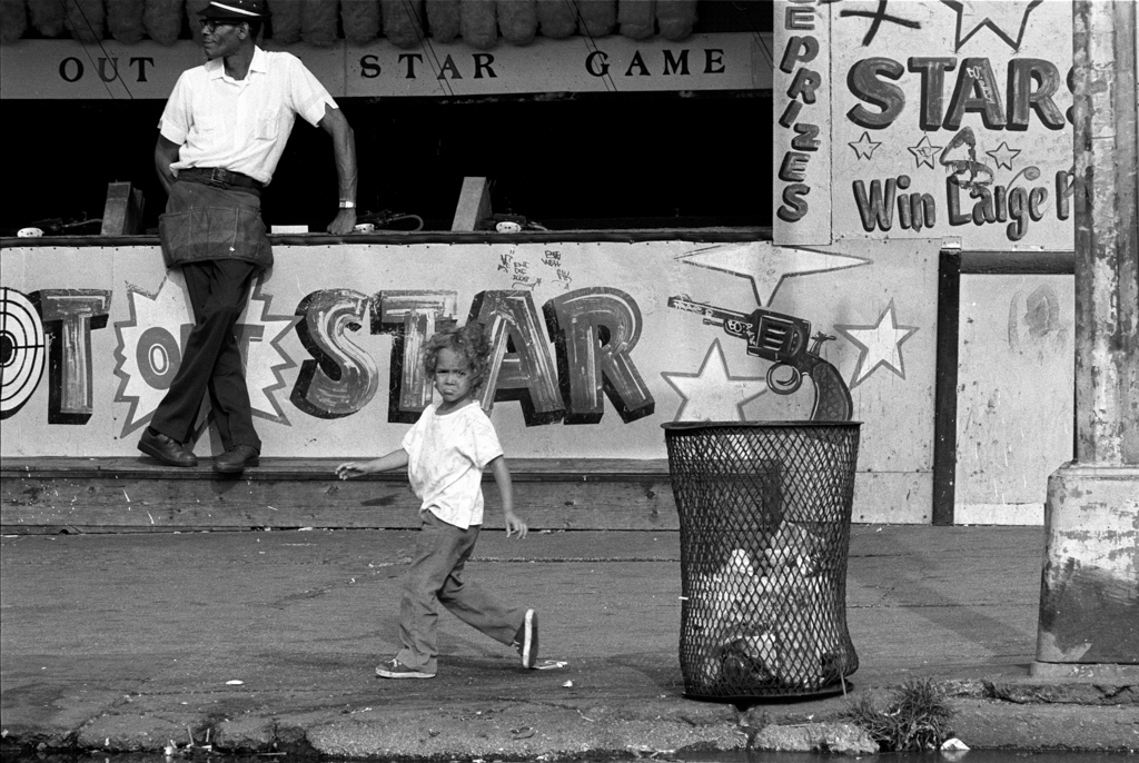 Child by shooting gallery, 1980