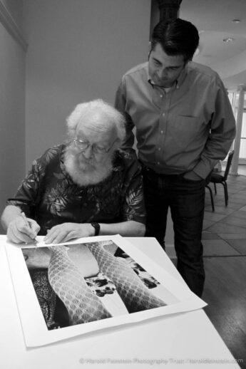 Photo: Harold Feinstein signs prints as Jason Landry watches on. title=